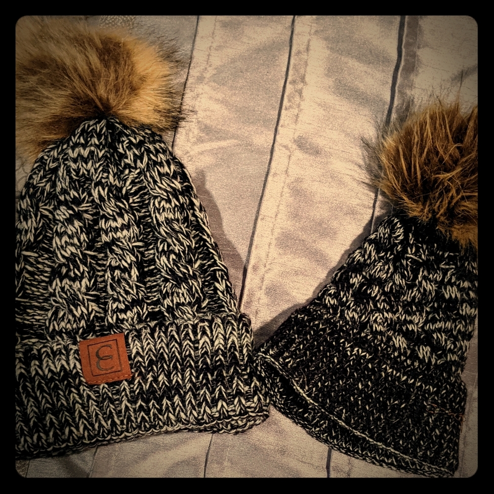 Mother and infant daughter matching winter hats